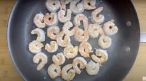 Sizzling shrimp cooking in a non-stick pan for delicious seafood recipes.